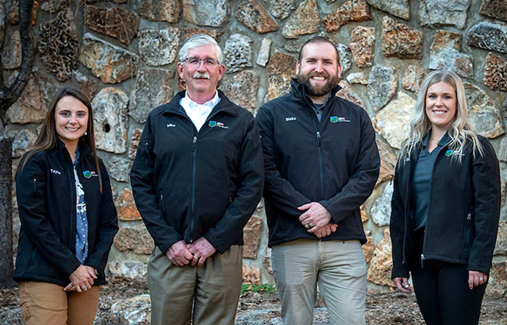 team members standing against wall