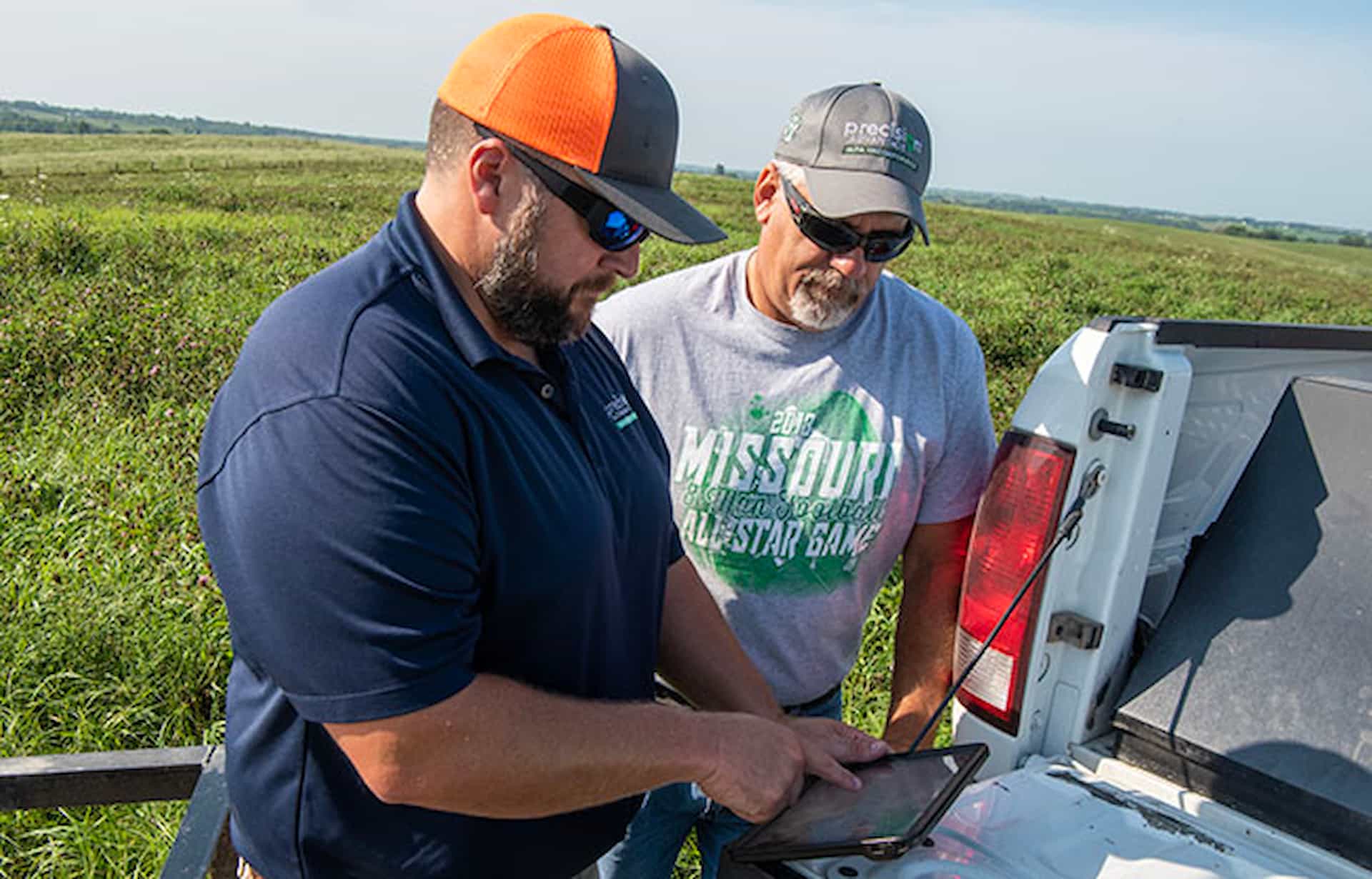 two men talking near farm equipment